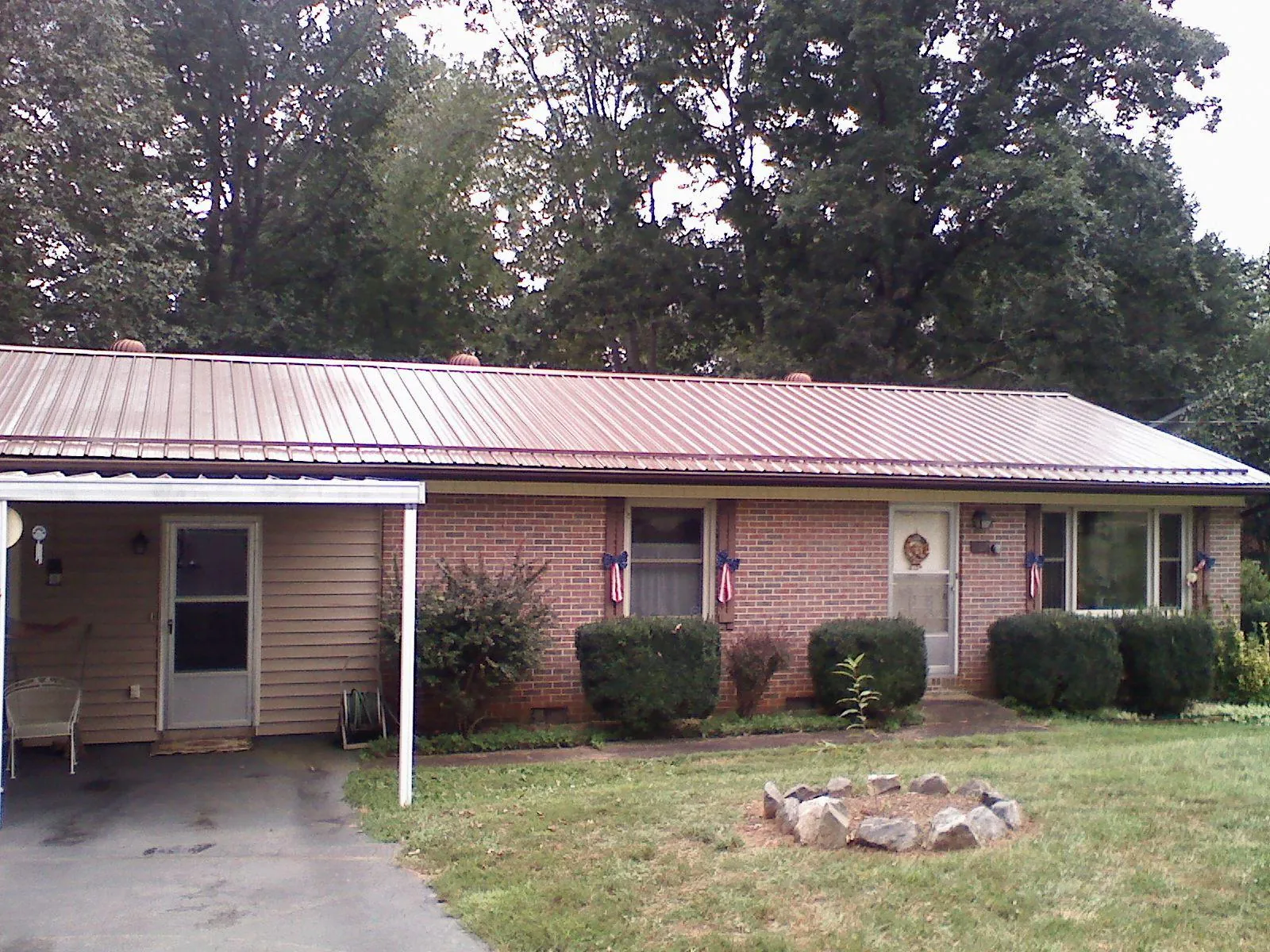 Bronze metal roof and carport on a brick ranch home — Roof Repair work by our crew in Katonah